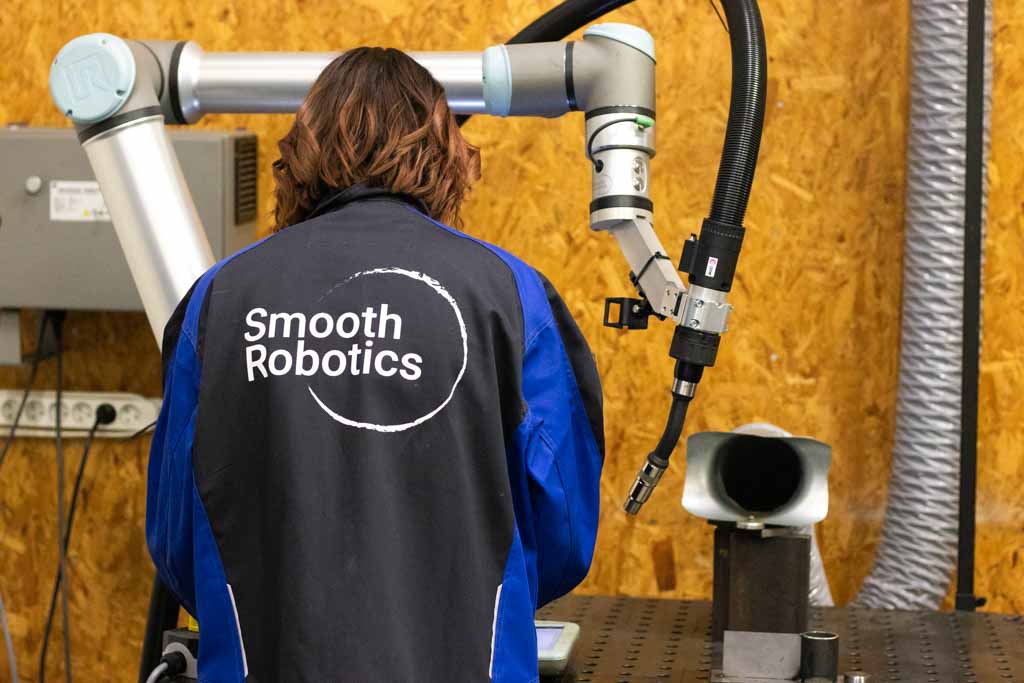 Optimize Your Cobot Welding System: 4 Must-Know Insights for a Profitable Investment 1 Woman welder standing with cobot welding system