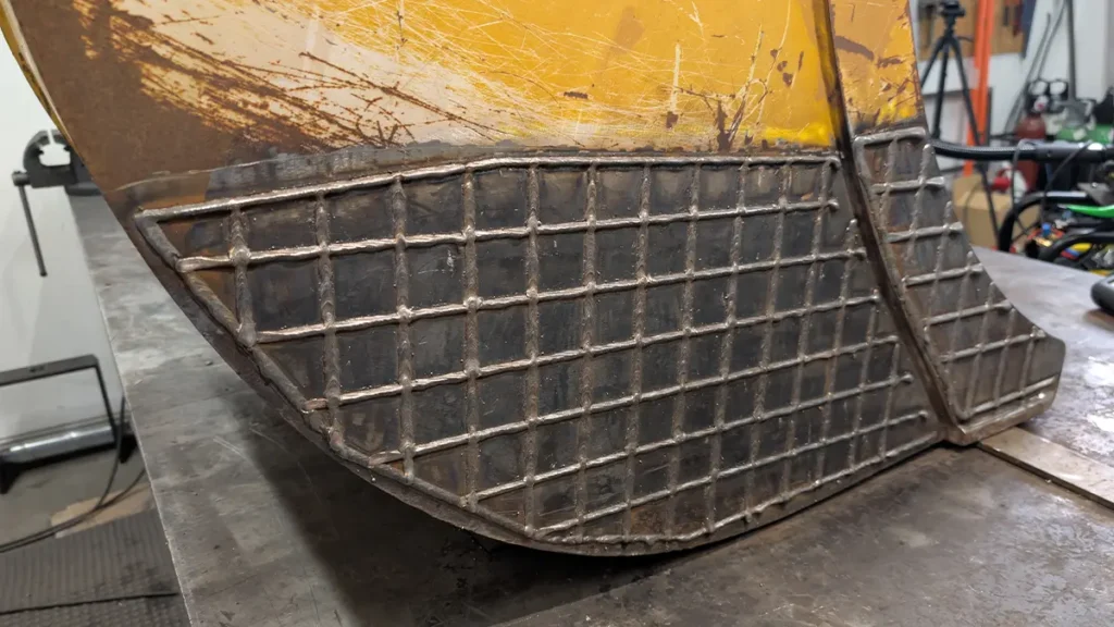Hardfacing mesh on excavator bucket