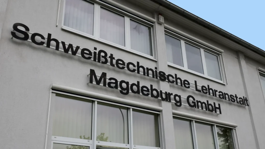 SLM Welding School Trains the Next Generation with Cobot Welding 1 A sign on a building reading "Schweisstechnische Lehranstalt Magdeburg GmbH"